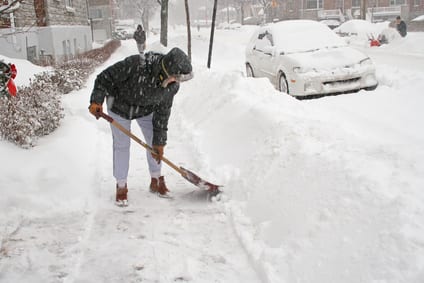 Woman shoveling after a snow storm. Canada.